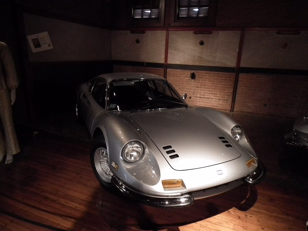 A silver 1969 Ferrari Dino 246 GT displayed inside the Larz Anderson Auto Museum