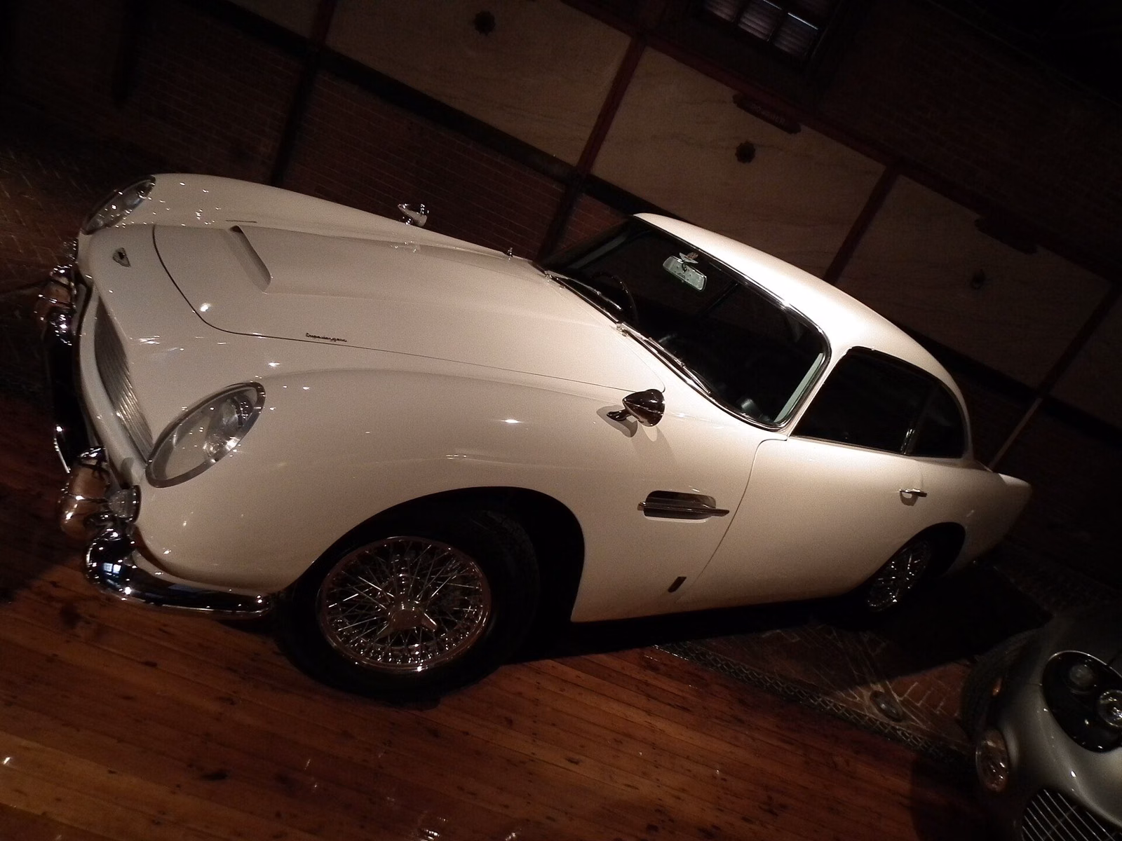 A white classic sports car on display at the Larz Anderson Auto Museum