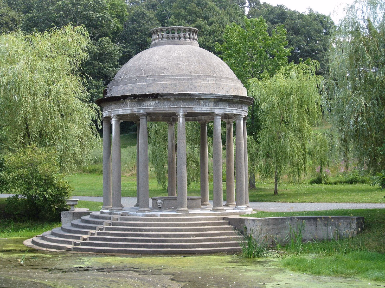 The rebuilt Temple of Love at Larz Anderson Park, a domed ring of columns on stone steps beside the lagoon
