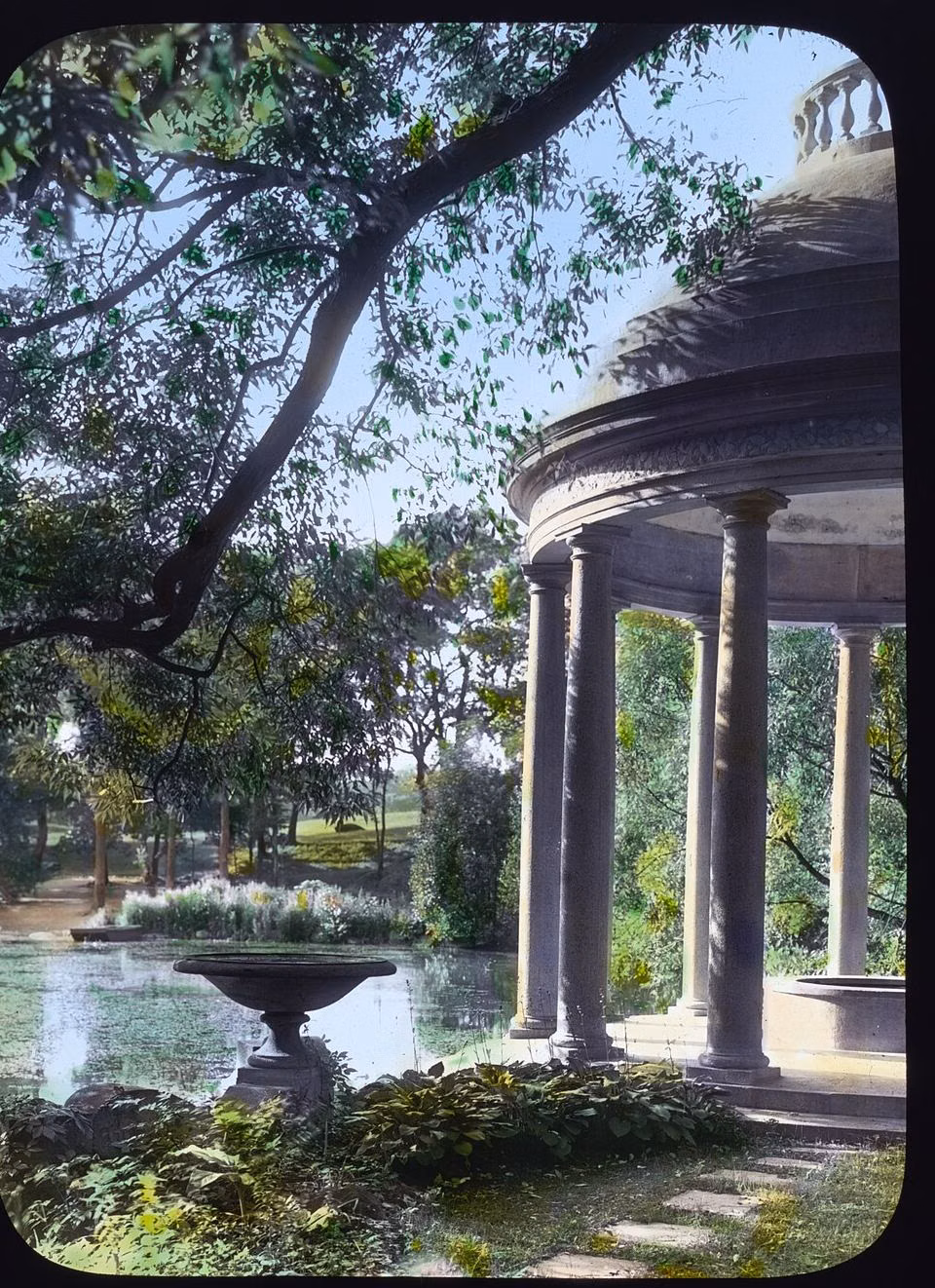 The temple at the end of the willow alley in the Andersons' water garden, in a hand-colored lantern slide from about 1914